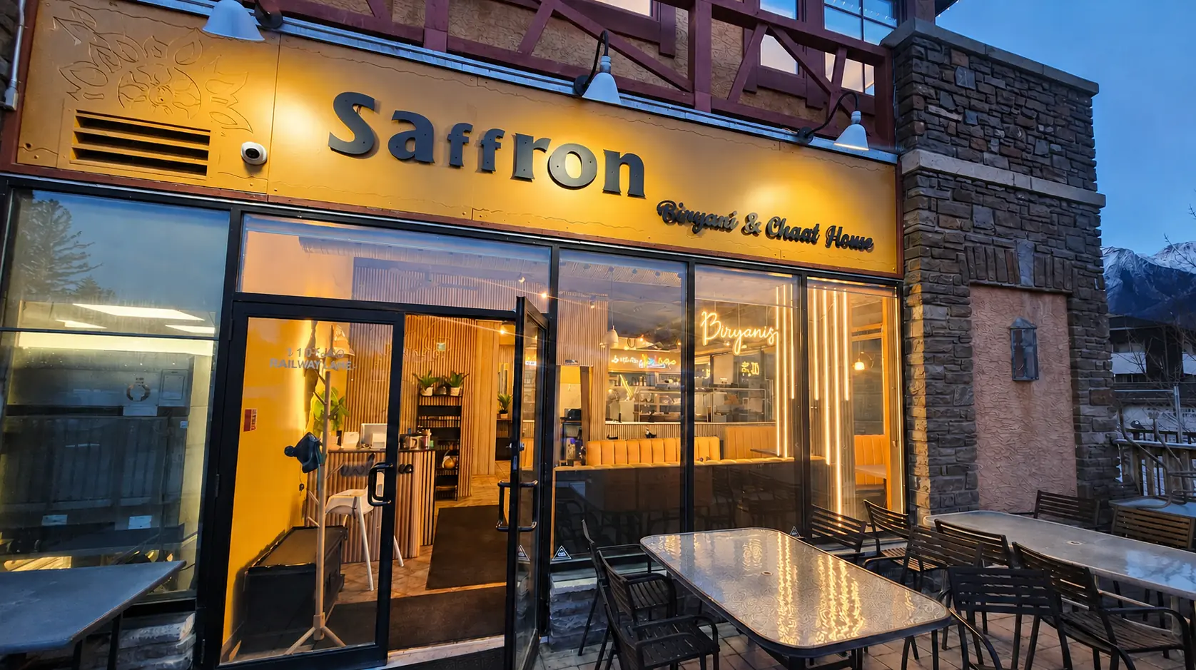 Saffron Indian family meal in the Canadian Rockies with naan, samosas, butter chicken and biryani